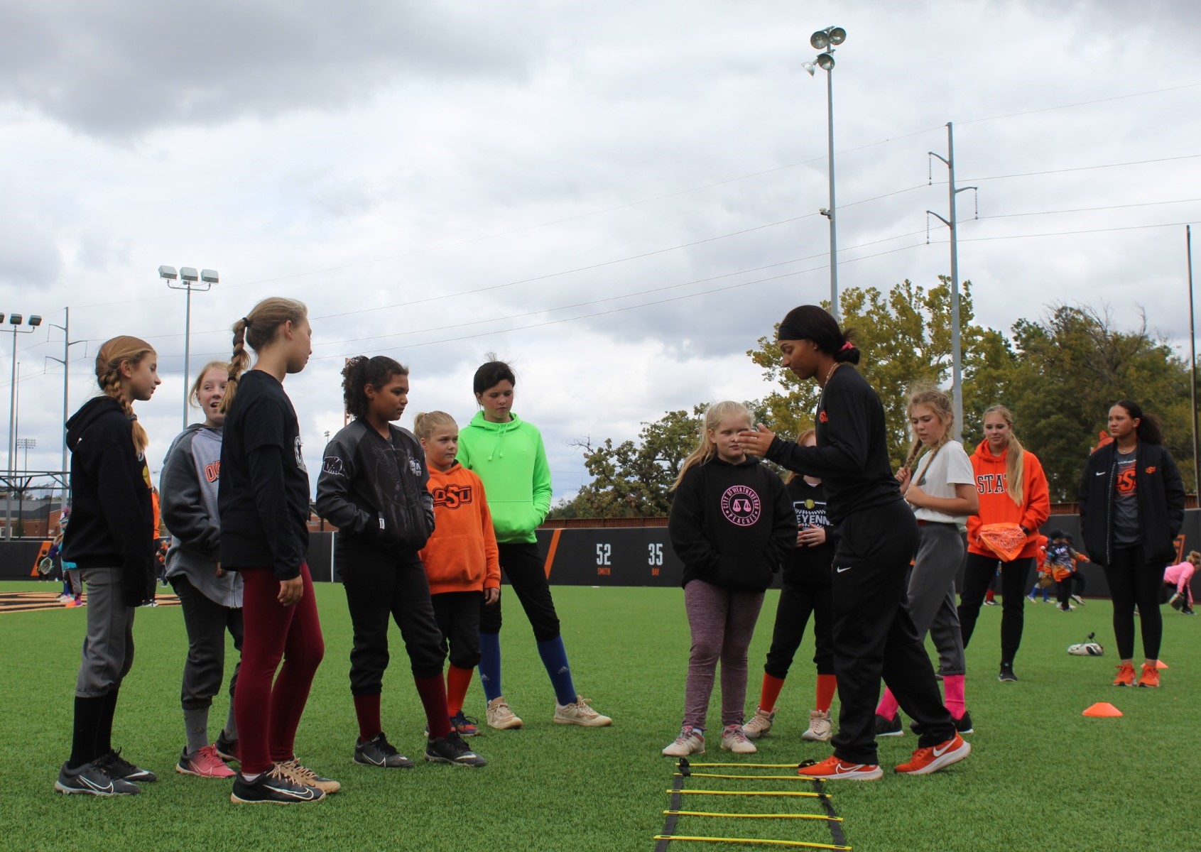 Oklahoma State softball standout Tallen Edwards tutors campers at the 2023 Playball Stillwater camp.